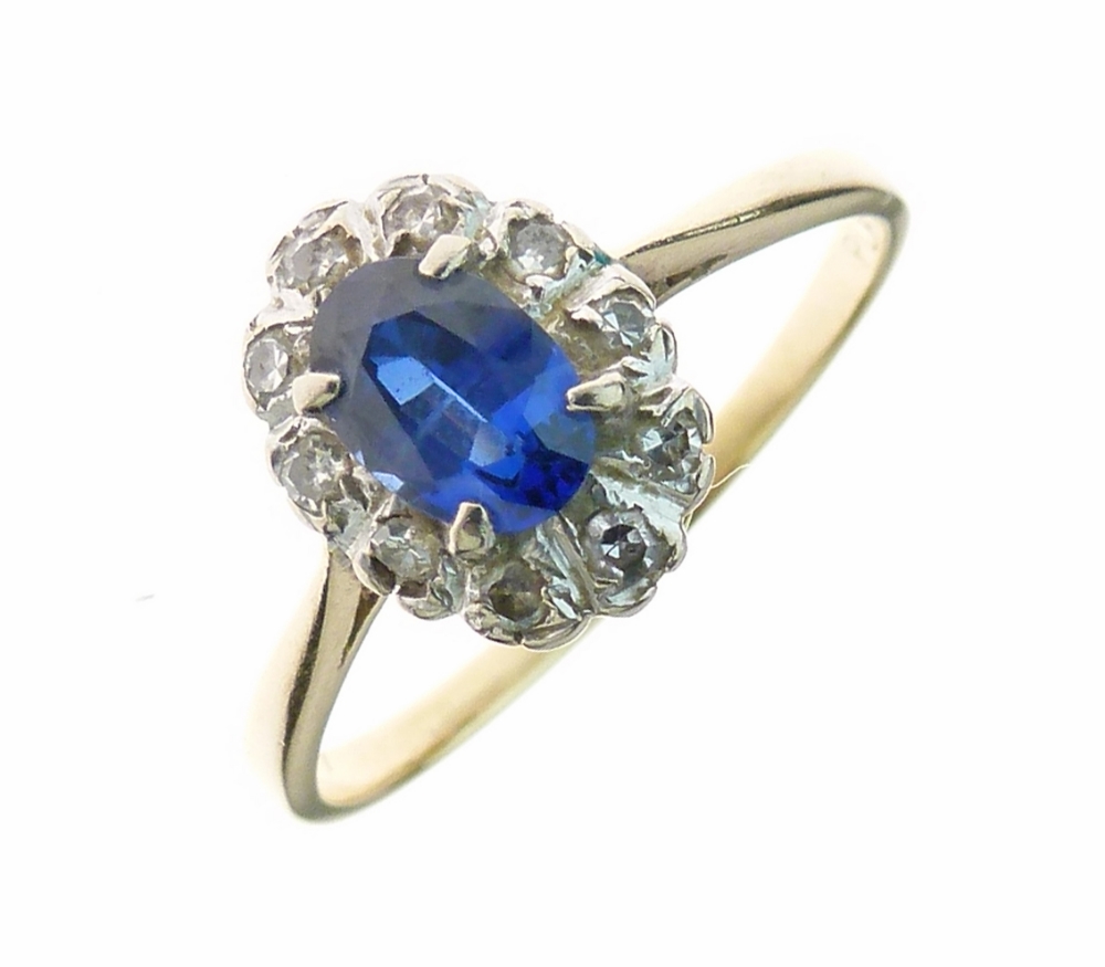 Sapphire and diamond cluster ring, the oval cut approximately 7mm long, enclosed by ten single cut