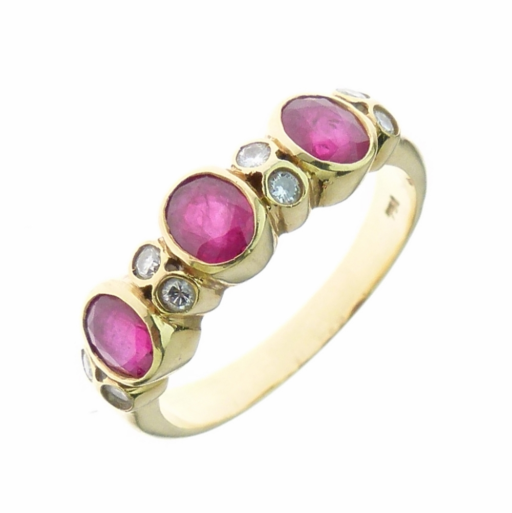 Ruby and diamond dress ring, the three oval cut stones with pairs of brilliant cut diamonds between,