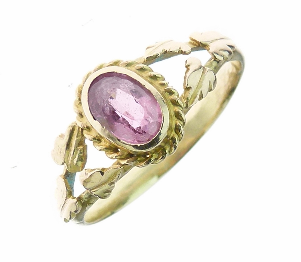 Arts & Crafts pink tourmaline gold ring, the oval cut stone flanked each side by oak leaves to the