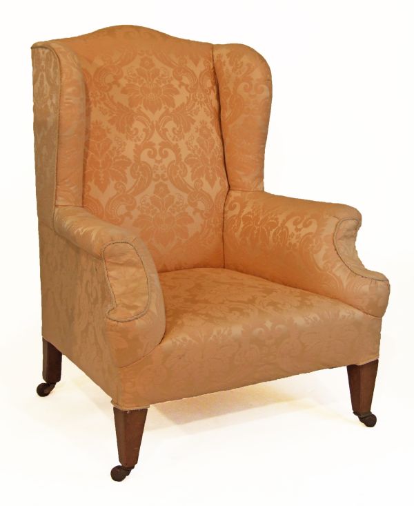 Early 20th Century wing back easy armchair upholstered in floral patterned peach brocade and