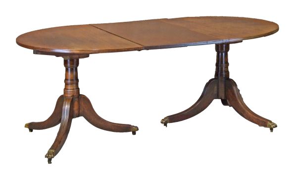 George III mahogany oval extending dining table having two snap top D ends and a single central