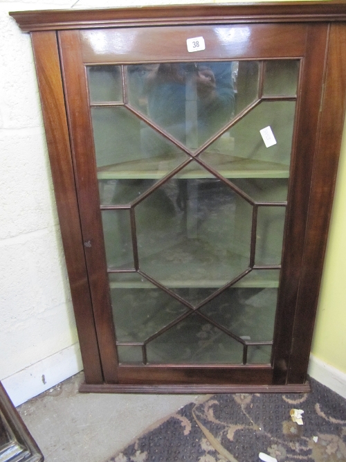 A glazed mahogany corner cupboard with astragal door.