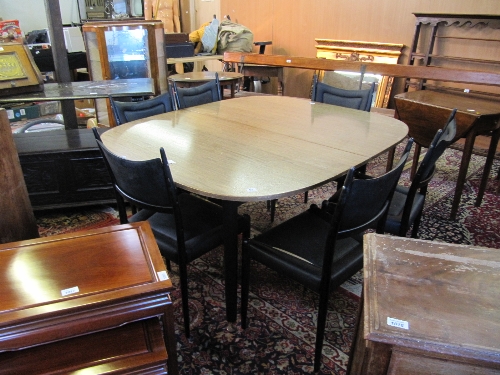 A large G plan draw-leaf table together with six leather effect dining chairs (matching).