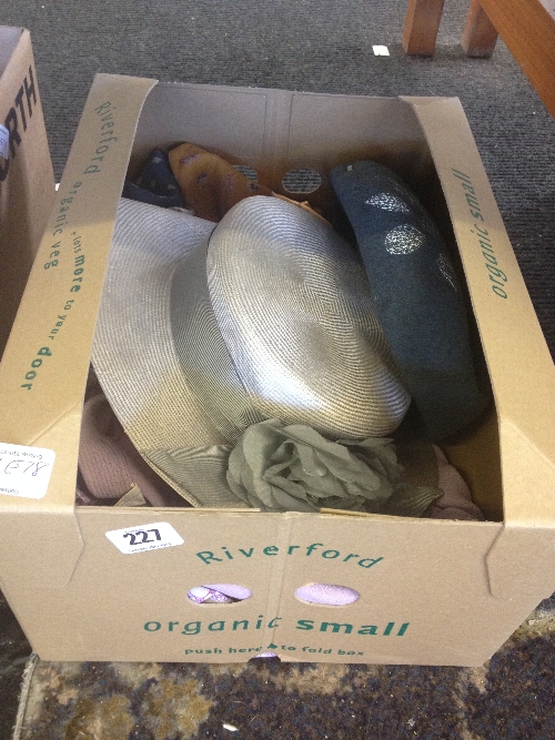 A box containing ladies' vintage clothing and hats.