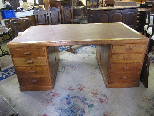A large oak leather inlaid partner's desk.
