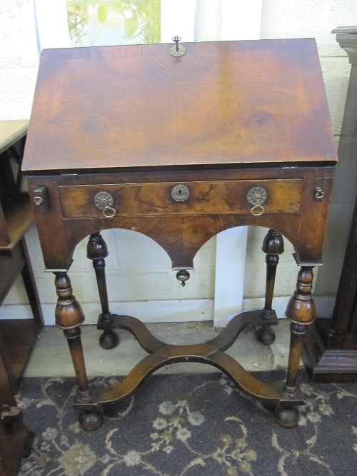 A 19th century ladies' walnut writing desk with oak interior, single drawer under, resting on turned