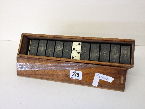 A double set of bone dominoes in original wooden case.