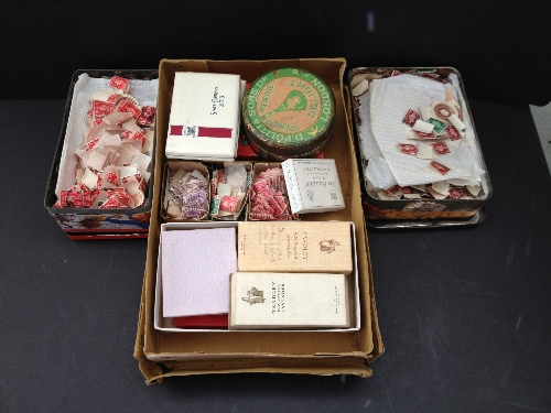 A box and two tins of stamps.