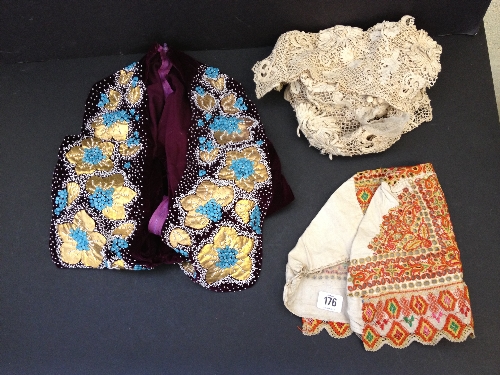 A purple velvet jacket with bead work decoration together with an early lace bonnet and a lace