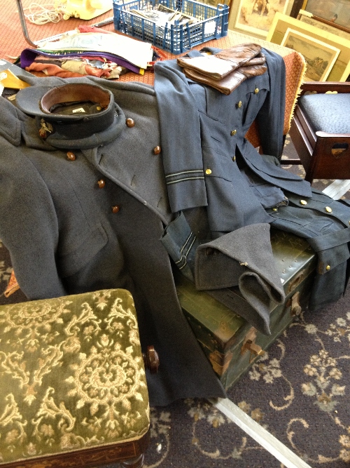 Two WWII period RAF uniforms together with a Great Coat, cap and a pair of leather gloves.