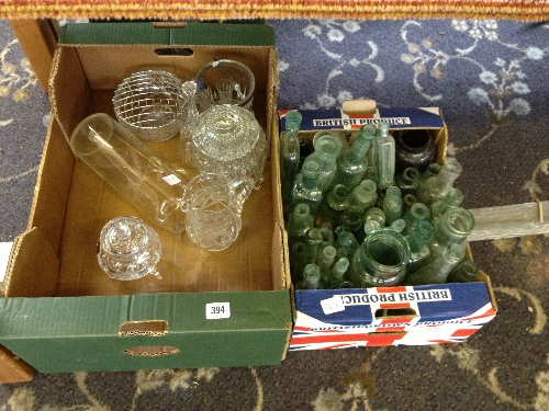 A box of early glass bottles together with a box of cut glass.