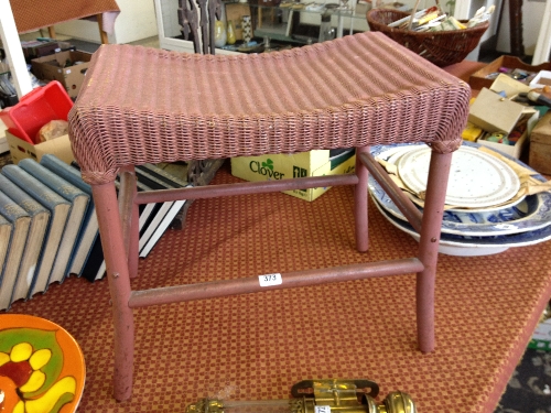 A pink Lloyd Loom dressing table stool.