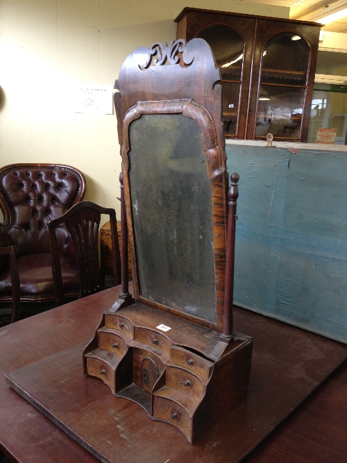 An 18th century walnut and mahogany dressing table swing mirror with seven drawers and small