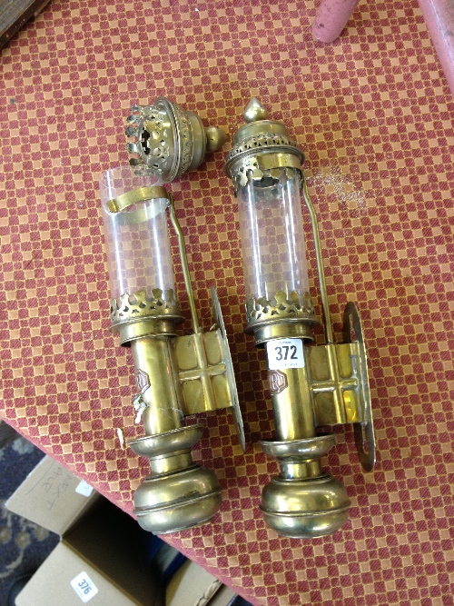 A pair of brass railway carriage lamps.