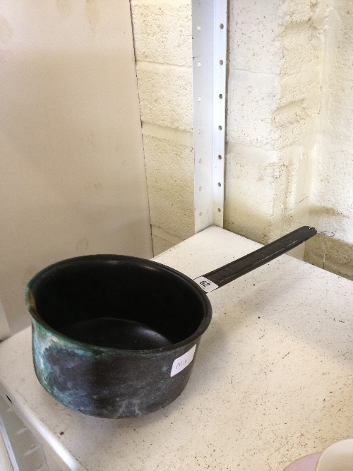 A bronze metal saucepan with handle inscribed `Exclemant Xtosearx`.