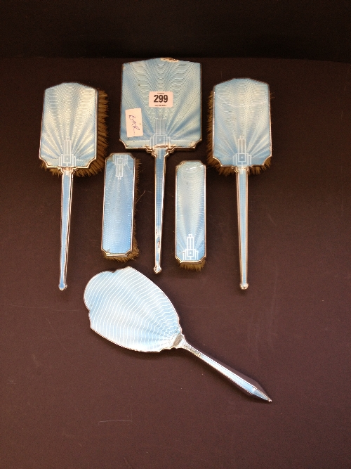A five piece Art Deco silver and light blue enamel dressing table mirror and brush set together with