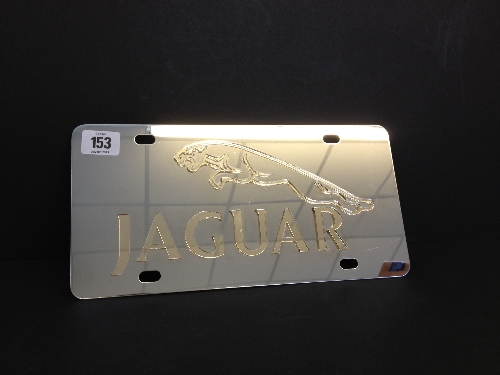 A Jaguar Showroom metal sign with leaping Jaguar symbol in relief.