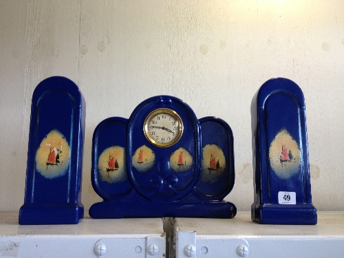 An early 20th century china Art Deco style clock garniture decorated with Sailing Boats.