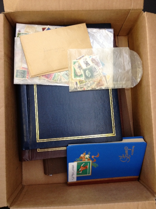 A box of four stamp albums together with a quantity of loose.