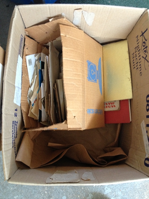 A box containing stamp albums and stamped envelopes.