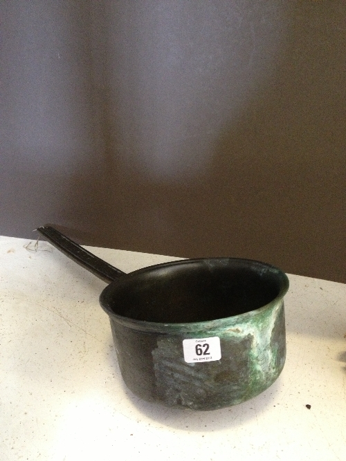 A bronze metal saucepan with handle inscribed `Exclemant Xtosearx`.