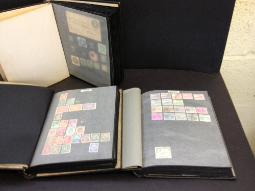 Three postage stamp albums and contents.