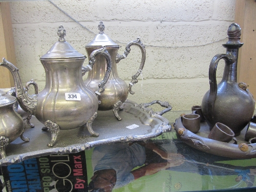 A four piece plated teaset and tray together with a Calvados pottery liqueur set.