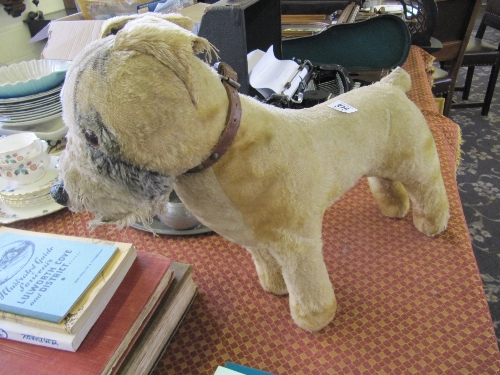 An early 20th century Chiltern golden plush toy dog with leather collar.