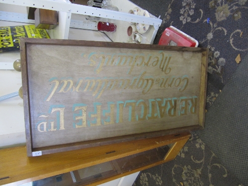 A painted wooden shop sign: R.E Ratcliffe Ltd, corn and agricultural Merchants.