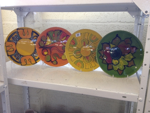 A collection of four Poole Pottery Delphis dishes, shape 4, decorated in various abstract patterns