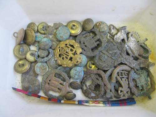 A small carton of Military badges and buttons.