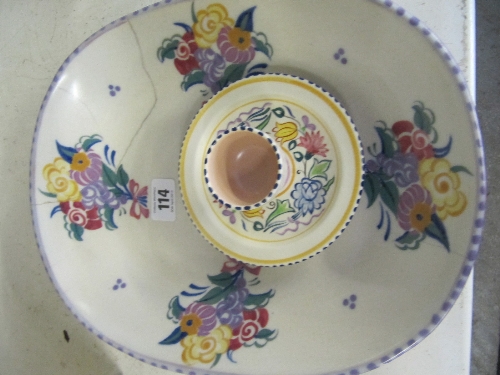 A white bodied Poole Pottery BN pattern egg cup on stand together with an early Poole Pottery red