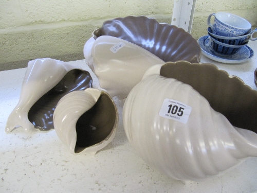 Four various mid 20th century Poole Pottery Twin Tone shell shaped ornaments (one minor chip).