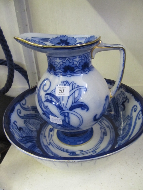 A Doulton Burslem Art Nouveau flow blue china jug and basin set decorated in a stylised floral