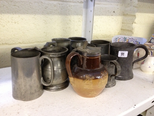 Nine various pewter tankards together with a Doulton stoneware jug decorated with Tavern and Hunting