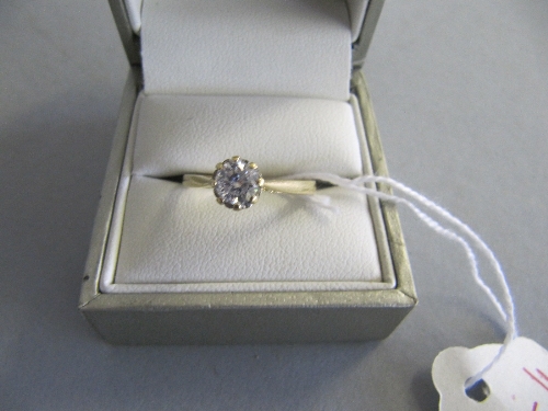 An 18 carat gold diamond solitaire ring.