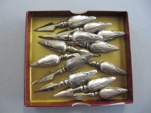 A set of twelve sterling silver corn-on-the-cob holders modelled as corn.