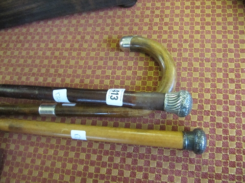 Three various silver mounted walking sticks.