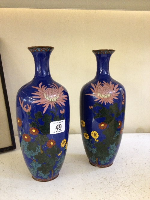 A pair of early 20th century Cloisonne bottle shaped vases decorated with Daisies and other