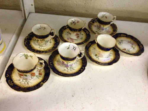 A set of six Edwardian china coffee cups and saucers decorated with flowers on cream and blue