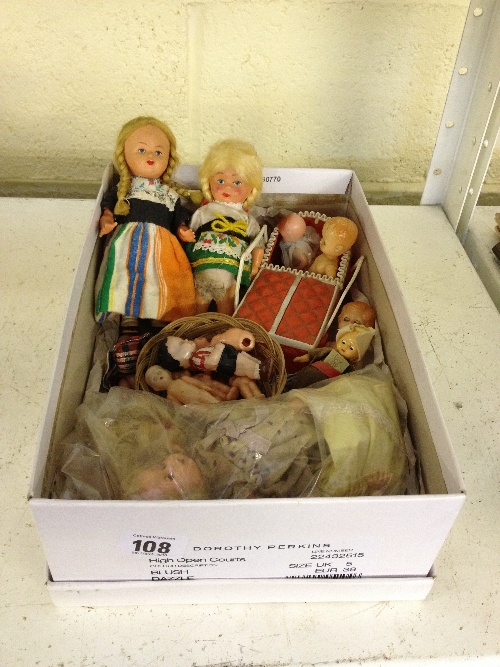 A box containing a quantity of plastic dolls including two wind-up walking dolls.