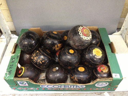 A box containing twenty one various wooden bowling woods.