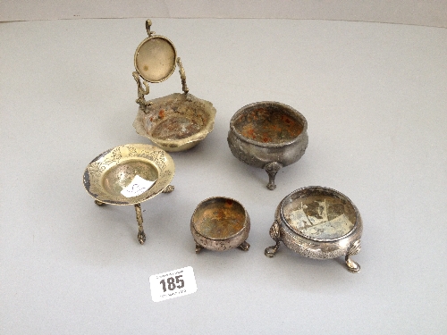 An early 20th century plated watch holder together with two small silver salts and two other salts.