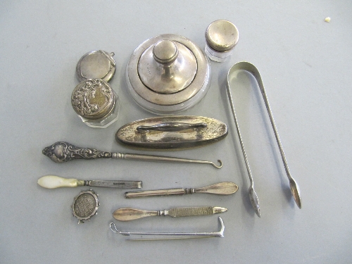 A collection of various silver items including a pair of silver sugar tongs, Art Nouveau silver