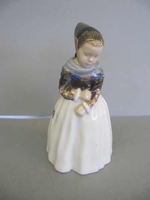 A small Royal Copenhagen china female figure modelled as a Young Girl touching the sleeve of her