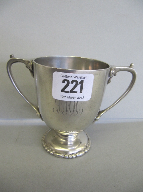 A small silver twin handled trophy cup: London 1922 (194g) by Wakely and Wheeler.