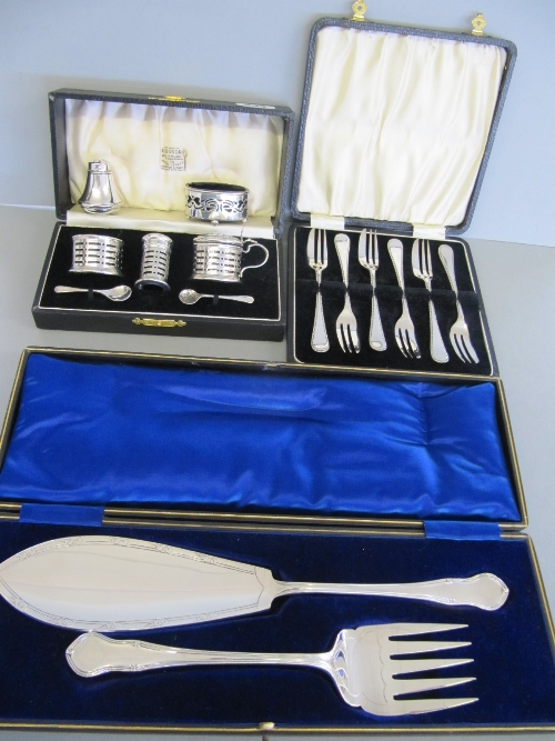 An early 20th century cased silver three piece cruet set together with a silver pepperette and salt,