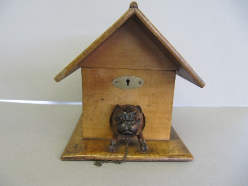 A late 19th/early 20th century Black Forest Dog in a Kennel wooden box with lift-top lid, the box