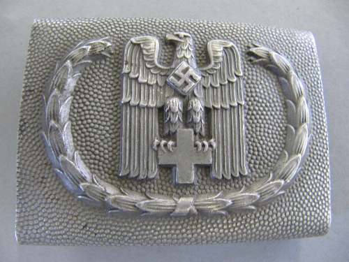 A WWII German Nazi metal Red Cross buckle decorated with Swastika Eagle and Cross.