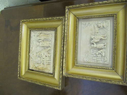A pair of Fontaine Petrifiante French moulded wall plaques decorated with Village Scenes.